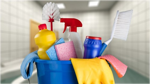 Cleaner in NW6 preparing safe cleaning equipment with protective gear