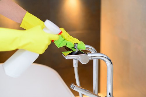 Cleaner preparing a well-maintained room in NW6